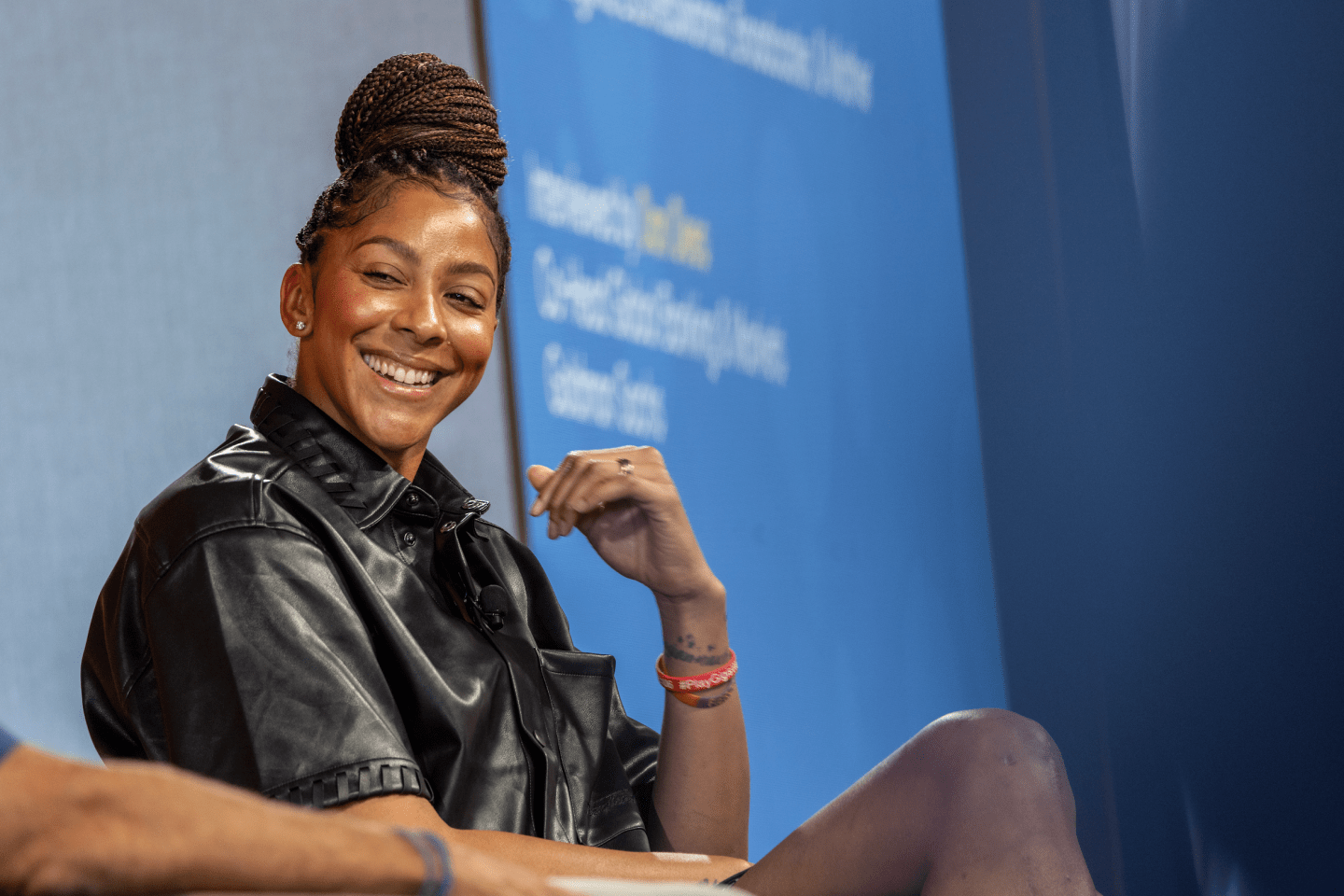 Candace Parker laughs in a black leather jacket.